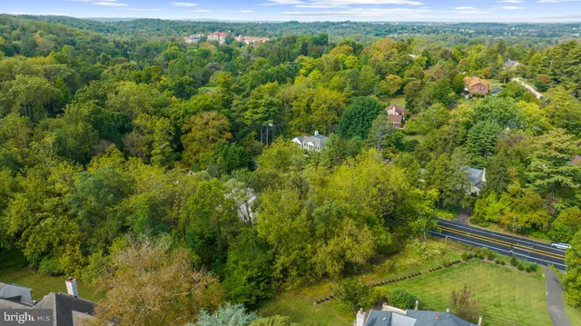 a view of a city and lush green forest