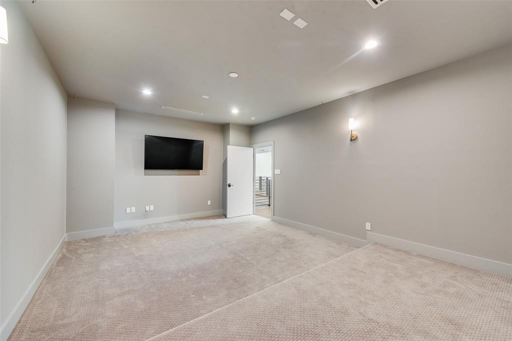 6411 Royal Lane Dallas, TX 75230 - Photo 13 of 35 a view of an empty room with wooden floor and a kitchen