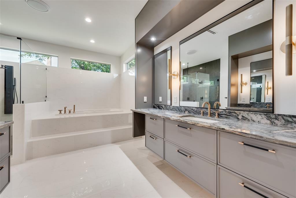 6411 Royal Lane Dallas, TX 75230 - Photo 18 of 35 a bathroom with a tub a sink and mirror