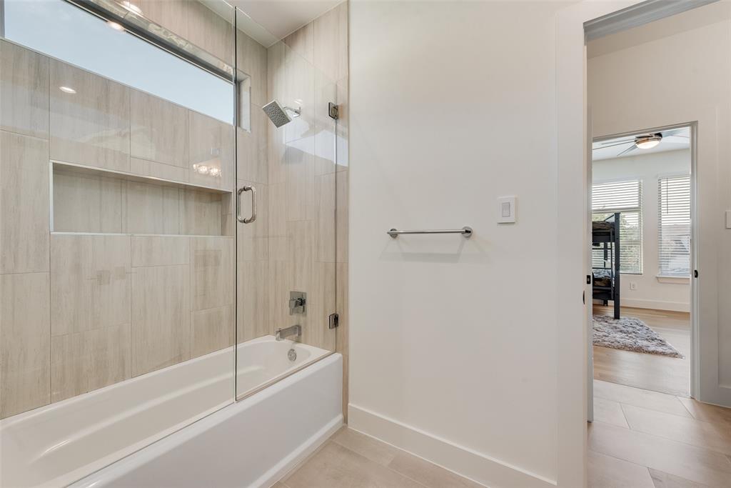 6411 Royal Lane Dallas, TX 75230 - Photo 25 of 35 a bathroom with a bathtub and a shower