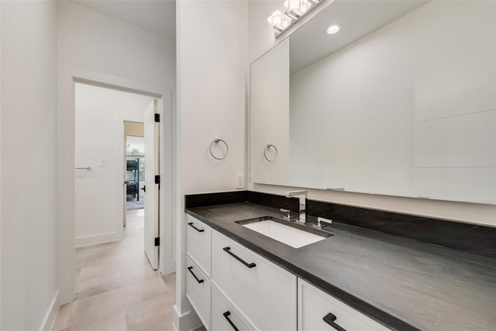 6411 Royal Lane Dallas, TX 75230 - Photo 26 of 35 a bathroom with a sink and a mirror