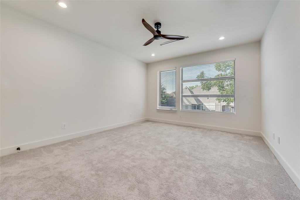 6411 Royal Lane Dallas, TX 75230 - Photo 28 of 35 an empty room with windows and ceiling fan