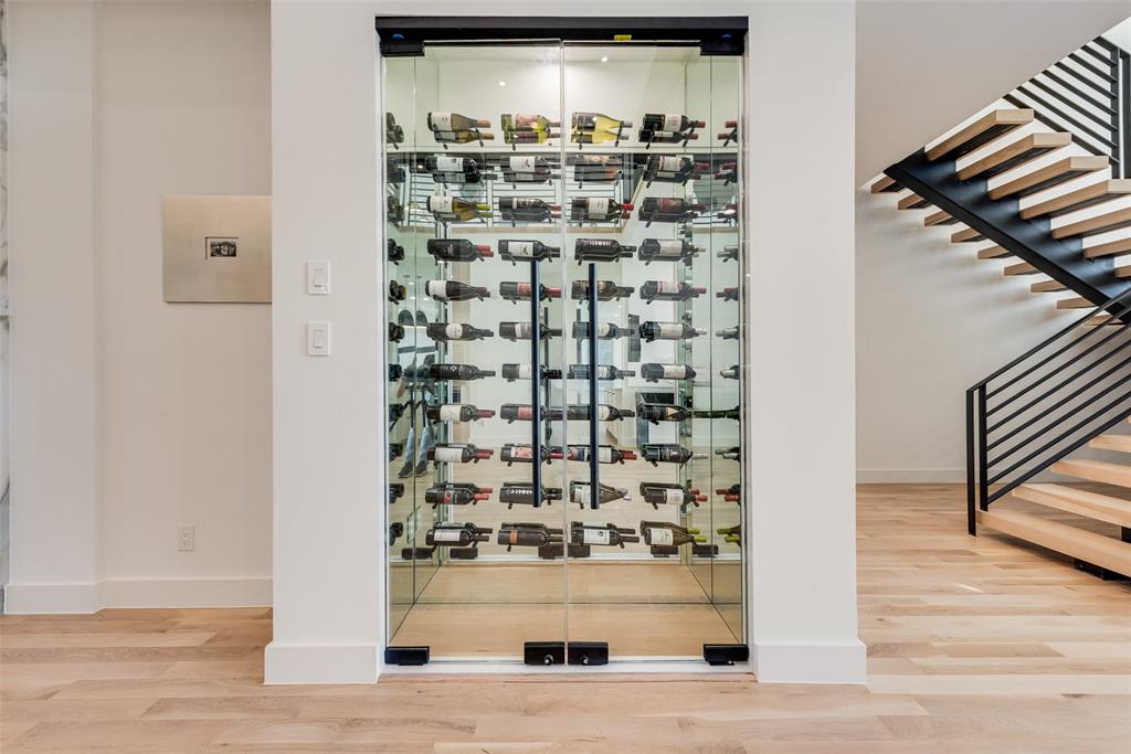6411 Royal Lane Dallas, TX 75230 - Photo 3 of 35 a view of a hallway with wooden floor and staircase