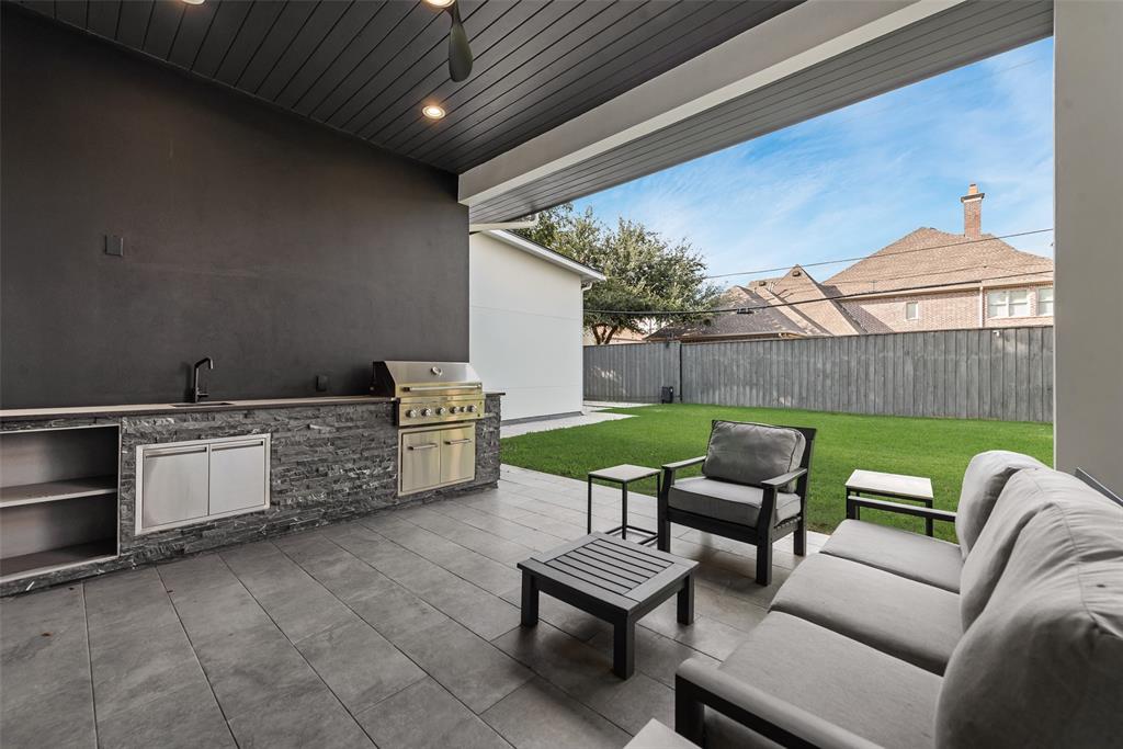 6411 Royal Lane Dallas, TX 75230 - Photo 32 of 35 a backyard of a house with barbeque oven table and chairs