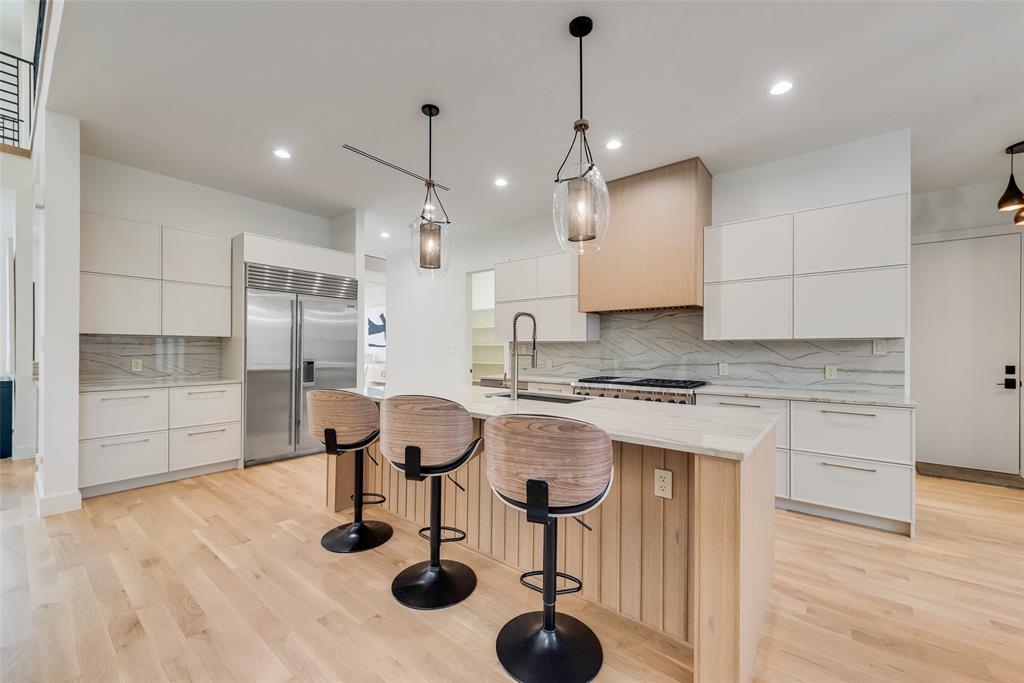 6411 Royal Lane Dallas, TX 75230 - Photo 5 of 35 a kitchen with cabinets and chairs