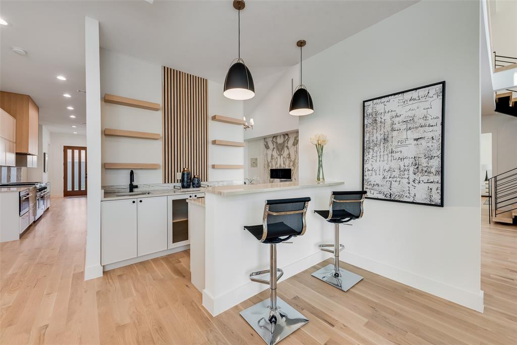 6411 Royal Lane Dallas, TX 75230 - Photo 7 of 35 a kitchen with stainless steel appliances kitchen island granite countertop a stove a sink and white cabinets with wooden floor