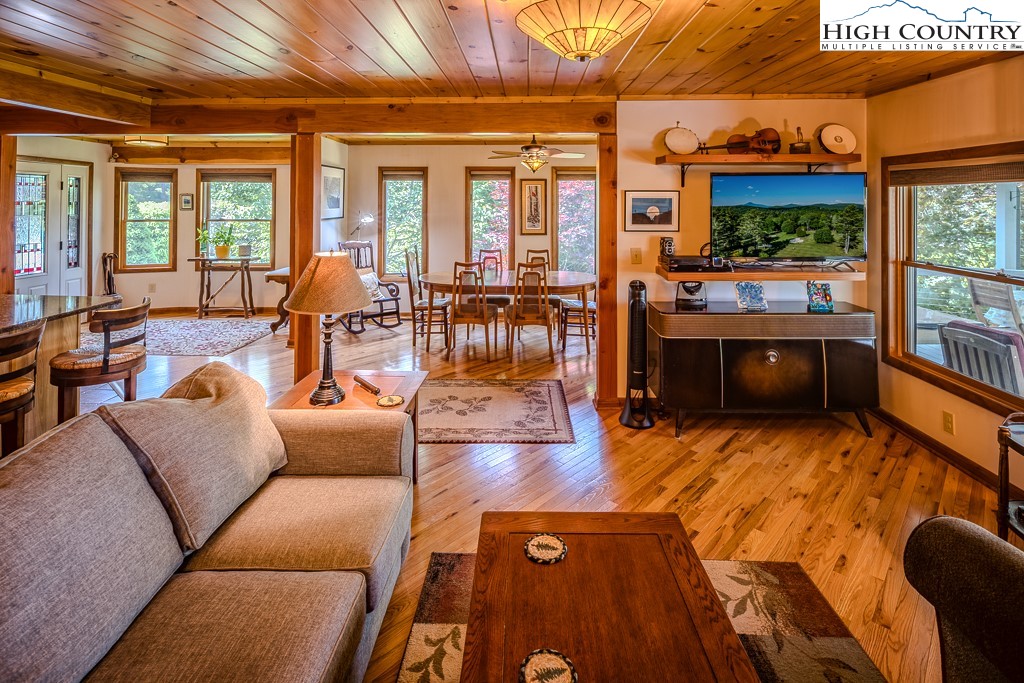 183 Rhododendron Loop Newland, NC 28657 - Photo 18 of 49 a living room with furniture and a floor to ceiling window