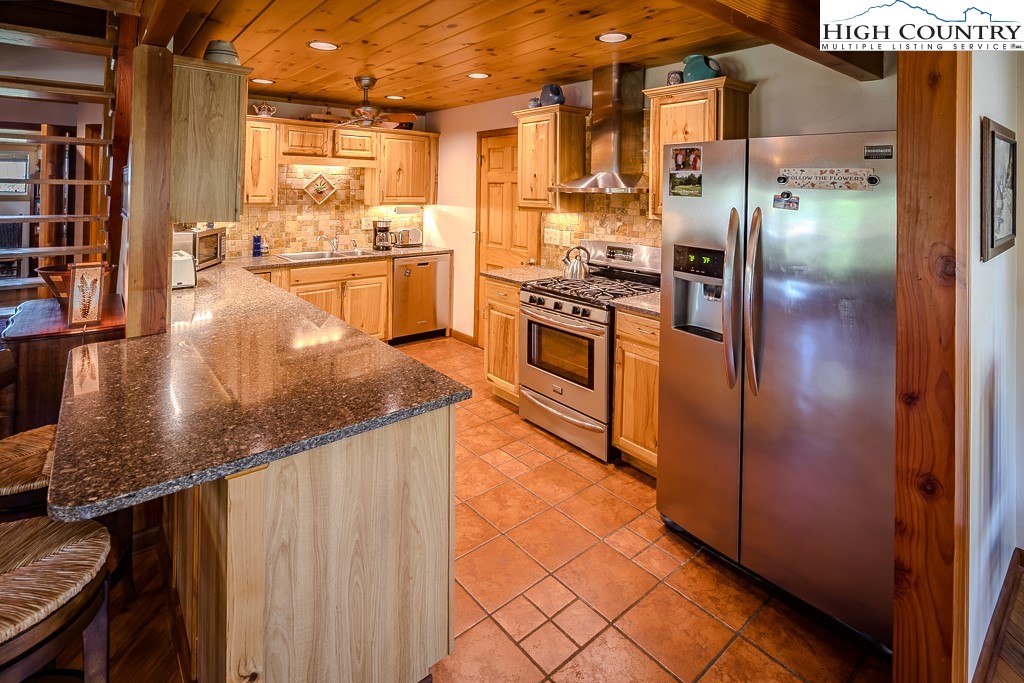 183 Rhododendron Loop Newland, NC 28657 - Photo 20 of 49 a kitchen with stainless steel appliances granite countertop a refrigerator and a stove