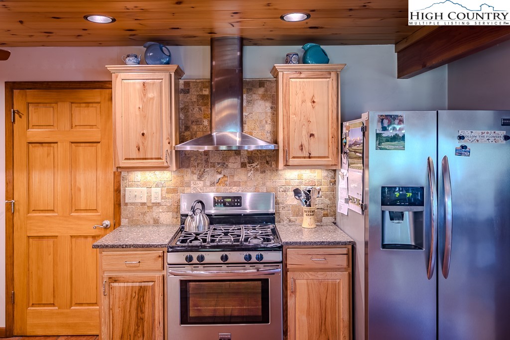 183 Rhododendron Loop Newland, NC 28657 - Photo 22 of 49 a stove top oven sitting inside of a kitchen