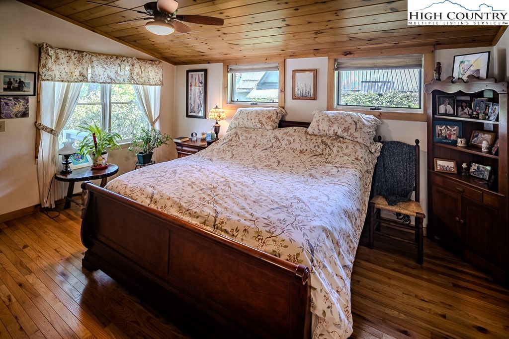 183 Rhododendron Loop Newland, NC 28657 - Photo 23 of 49 a bed sitting in a bedroom next to a window