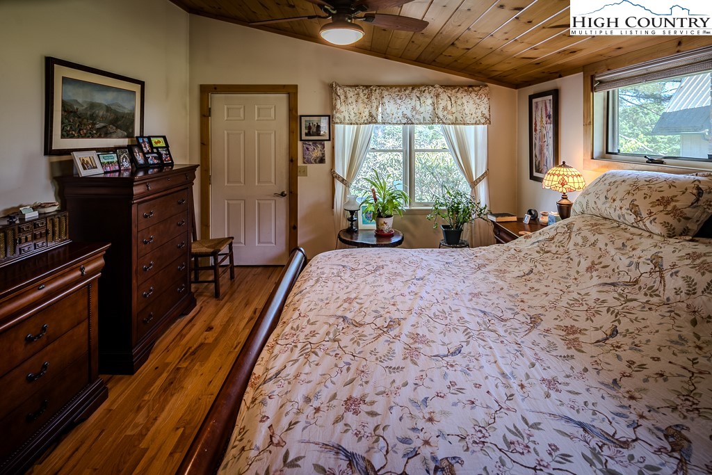 183 Rhododendron Loop Newland, NC 28657 - Photo 24 of 49 a bed sitting in a spacious bedroom next to a window