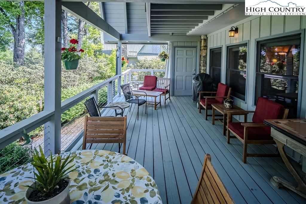 183 Rhododendron Loop Newland, NC 28657 - Photo 34 of 49 an outdoor sitting area with furniture and wooden floor