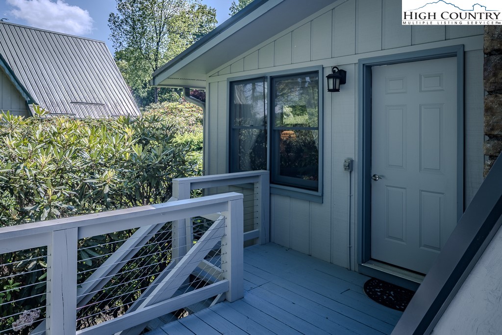 183 Rhododendron Loop Newland, NC 28657 - Photo 37 of 49 a view of a balcony with furniture and wooden floor