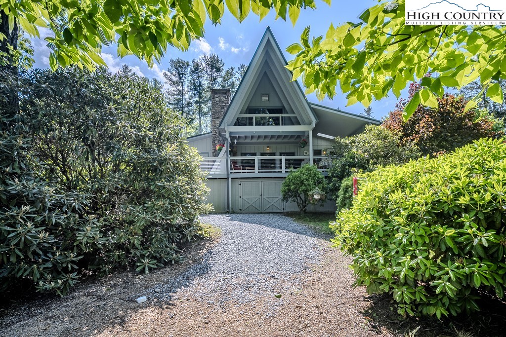 183 Rhododendron Loop Newland, NC 28657 - Photo 38 of 49 a view of a house with a tree in front of it