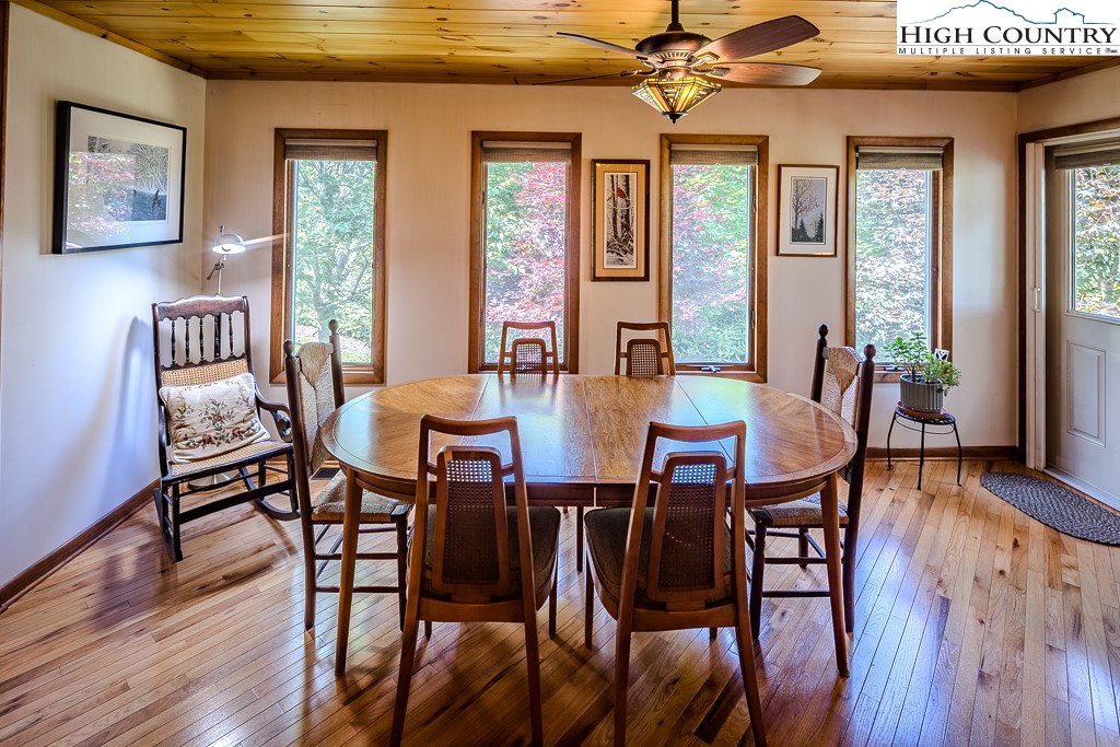 183 Rhododendron Loop Newland, NC 28657 - Photo 8 of 49 a view of a dining room with furniture window and wooden floor