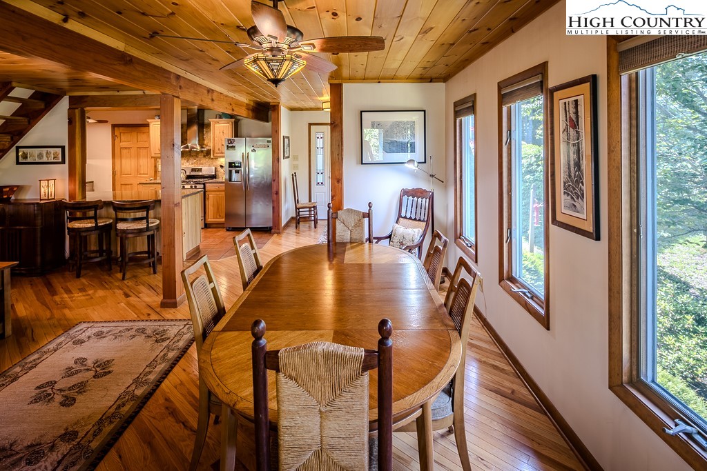183 Rhododendron Loop Newland, NC 28657 - Photo 10 of 49 a dining room with furniture a chandelier and wooden floor