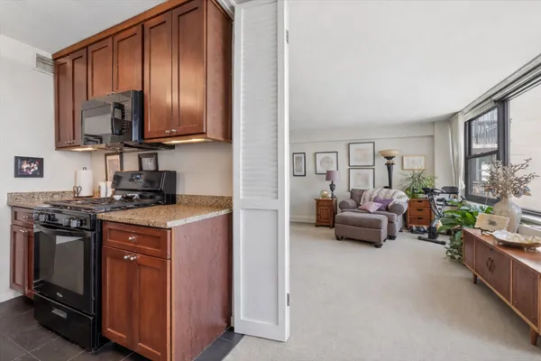 a kitchen with stainless steel appliances granite countertop a stove a sink dishwasher and a refrigerator