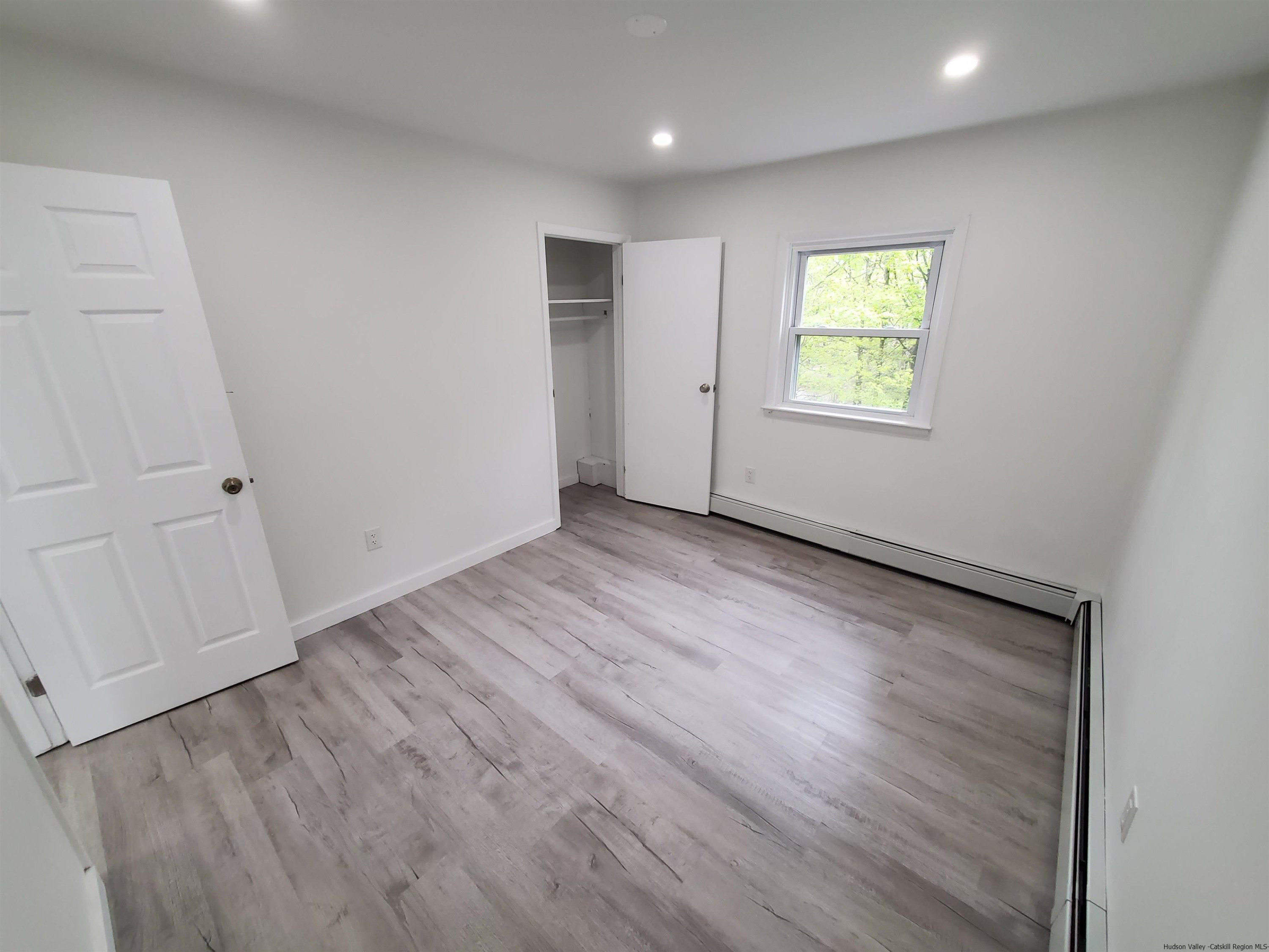 326 Boulevard Kingston, NY 12401 - Photo 12 of 35 wooden floor in an empty room with a window