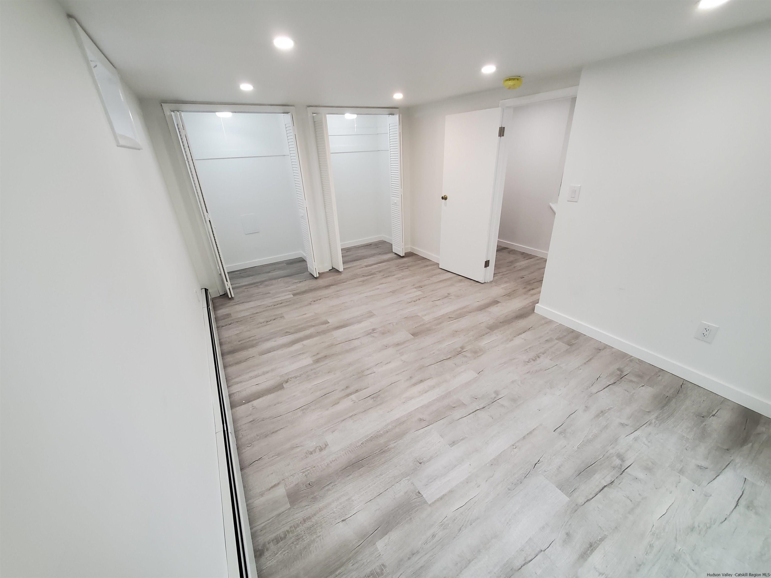 326 Boulevard Kingston, NY 12401 - Photo 24 of 35 an empty room with wooden floor and windows