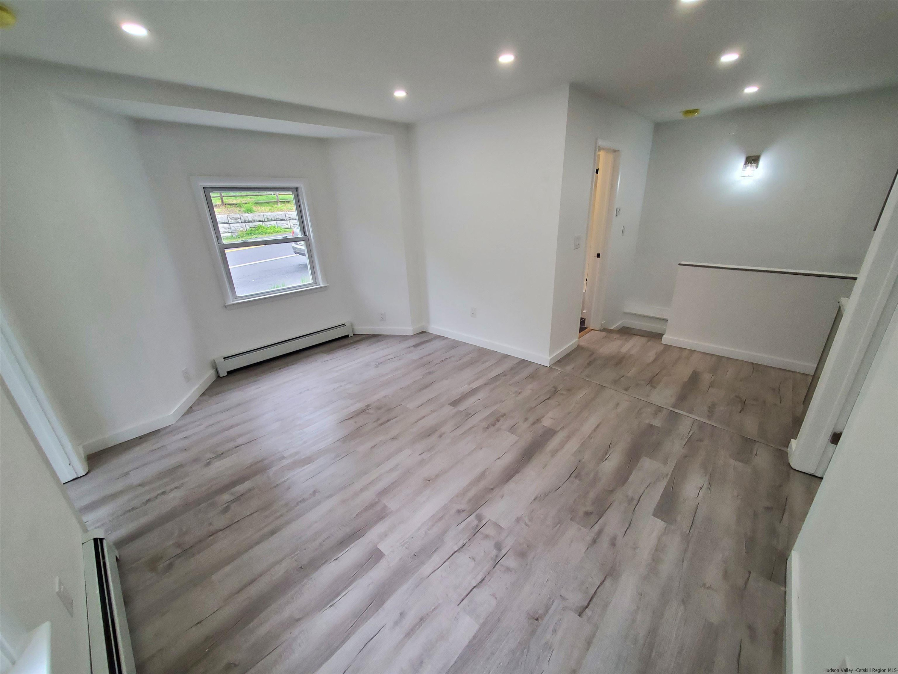 326 Boulevard Kingston, NY 12401 - Photo 6 of 35 an empty room with wooden floor and a window