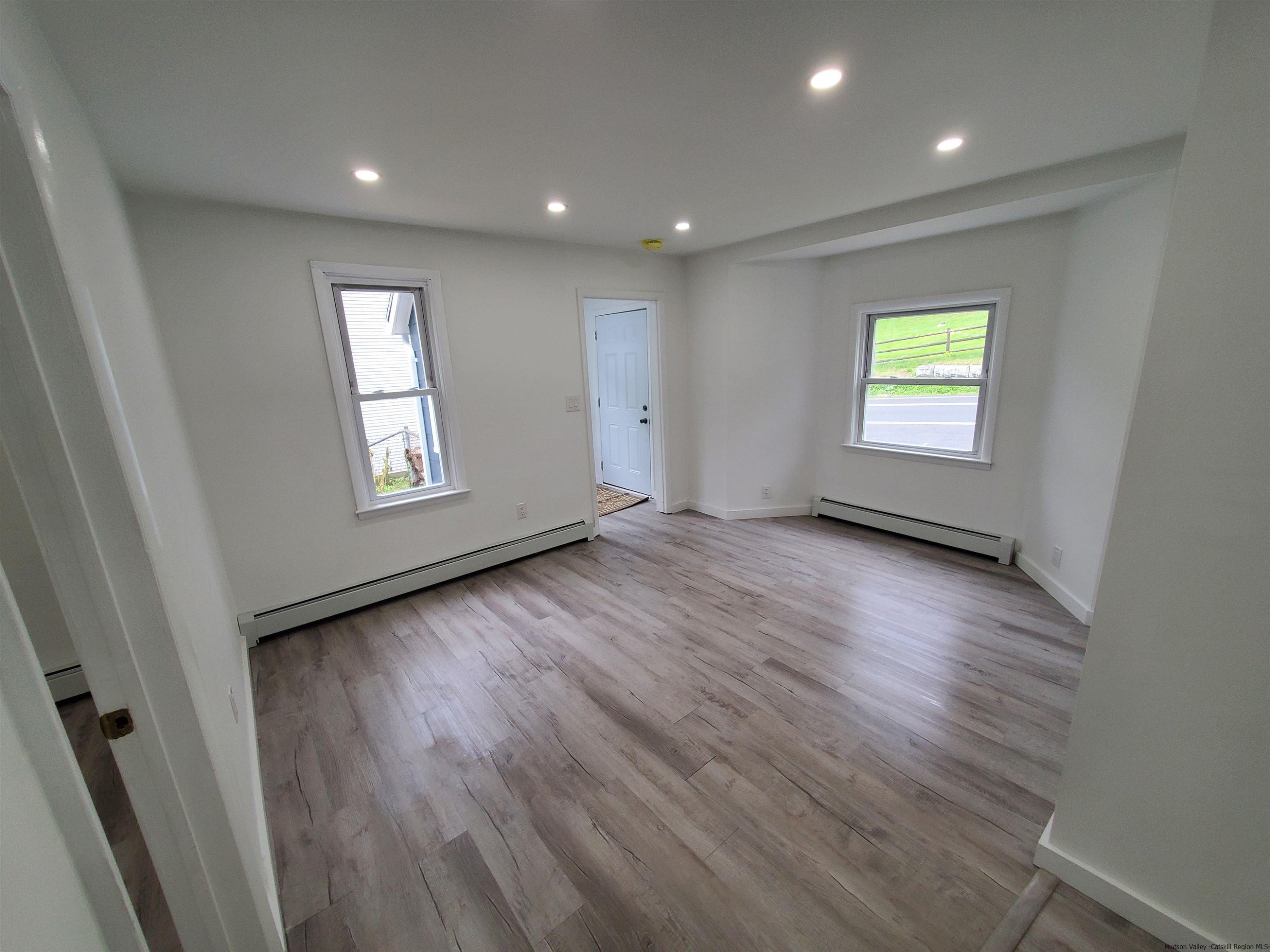 326 Boulevard Kingston, NY 12401 - Photo 7 of 35 an empty room with wooden floor and windows