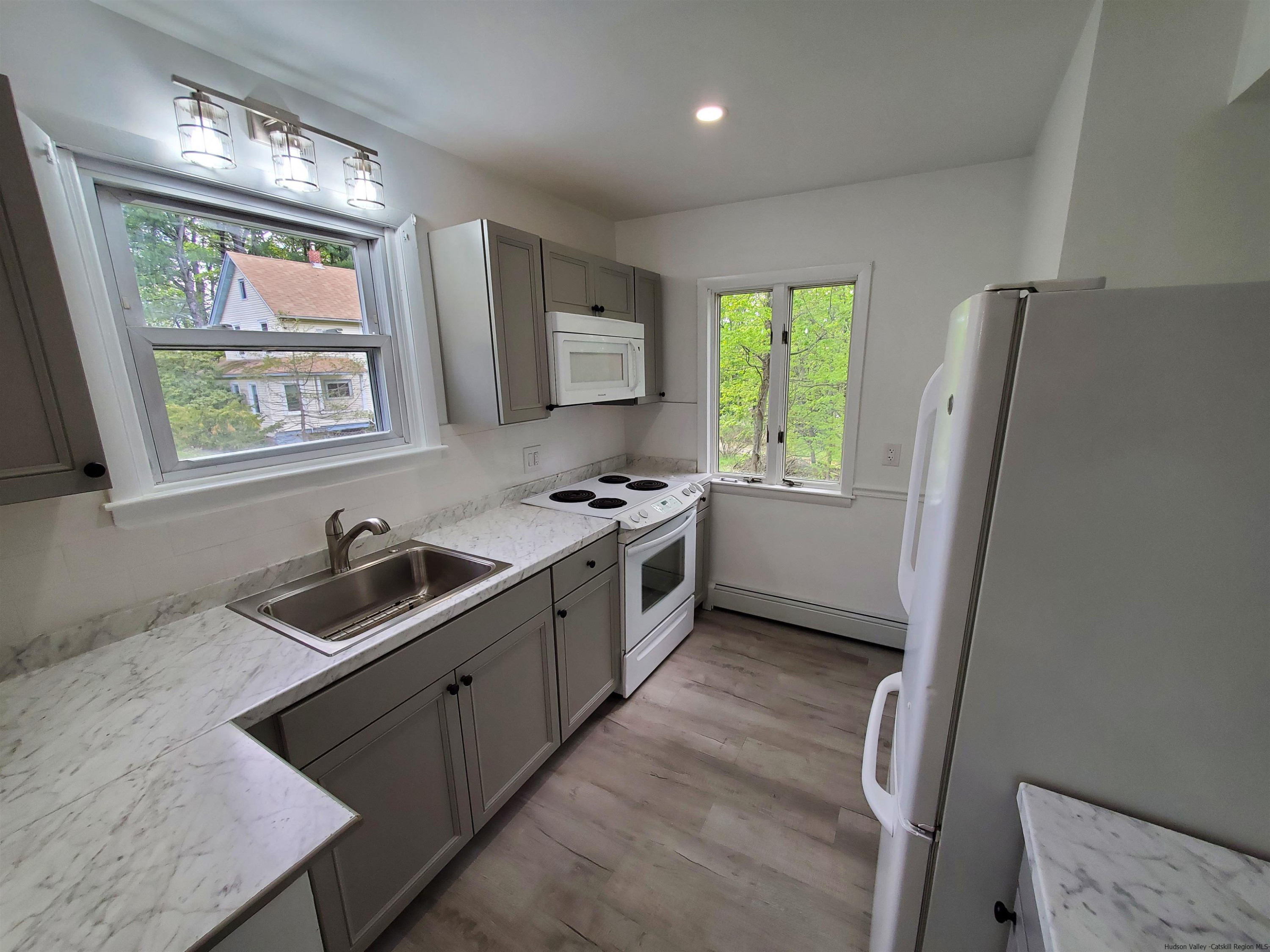 326 Boulevard Kingston, NY 12401 - Photo 8 of 35 a kitchen that has a sink a window and stainless steel appliances