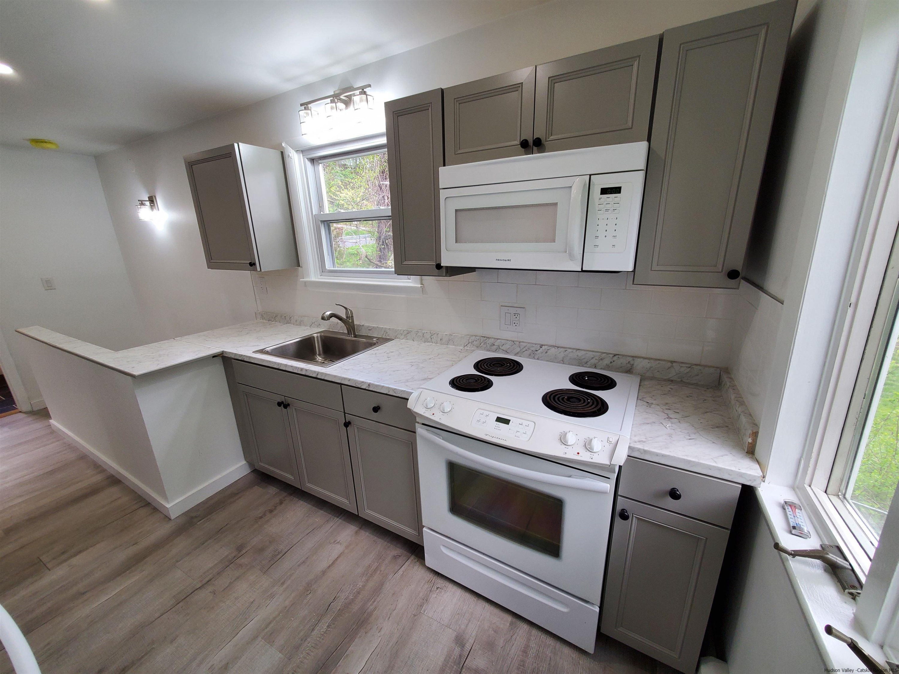 326 Boulevard Kingston, NY 12401 - Photo 9 of 35 a kitchen with white cabinets and white appliances