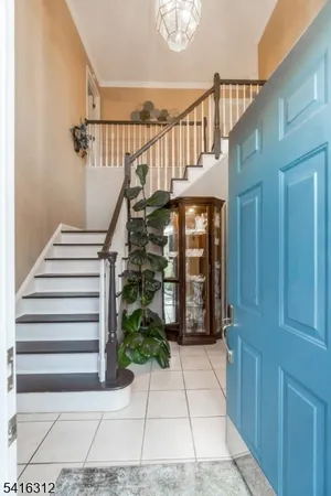a kitchen with stainless steel appliances granite countertop a refrigerator a stove and a sink with wooden floor