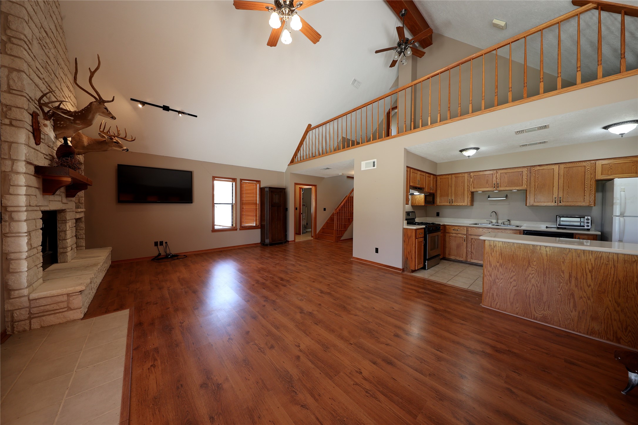 3337 Brunes Mill Road Columbus, TX 78934 - Photo 11 of 48 a view of a living room and kitchen with furniture wooden floor and windows