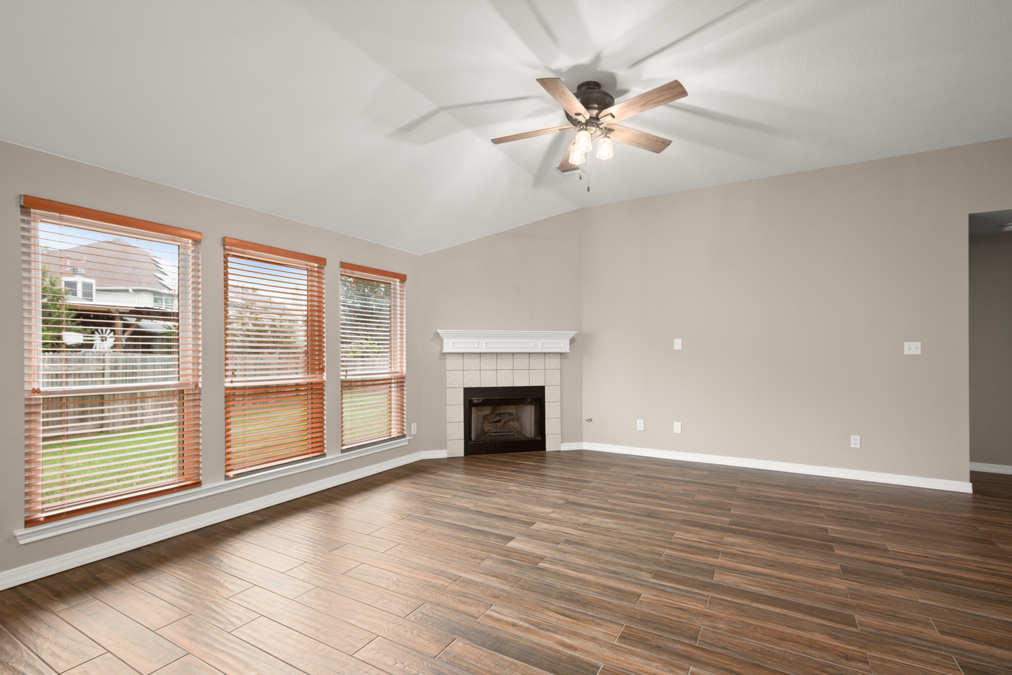 3420 Ribbon Reef Lane Austin, TX 78728 - Photo 10 of 25 Family room with wall of windows overlooking backyard