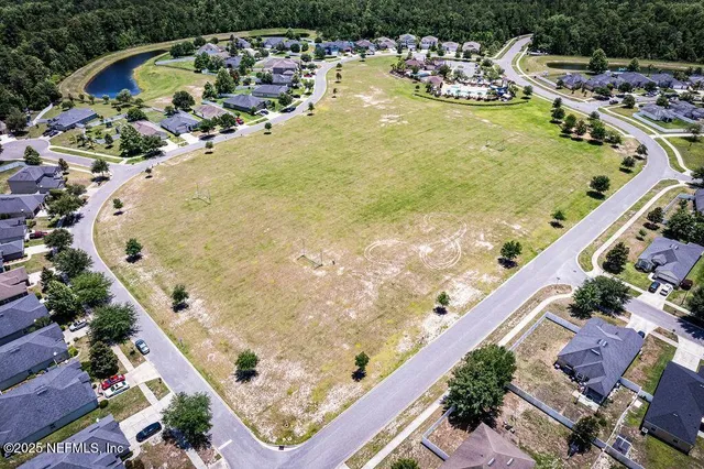 an aerial view of a house with outdoor space and swimming pool