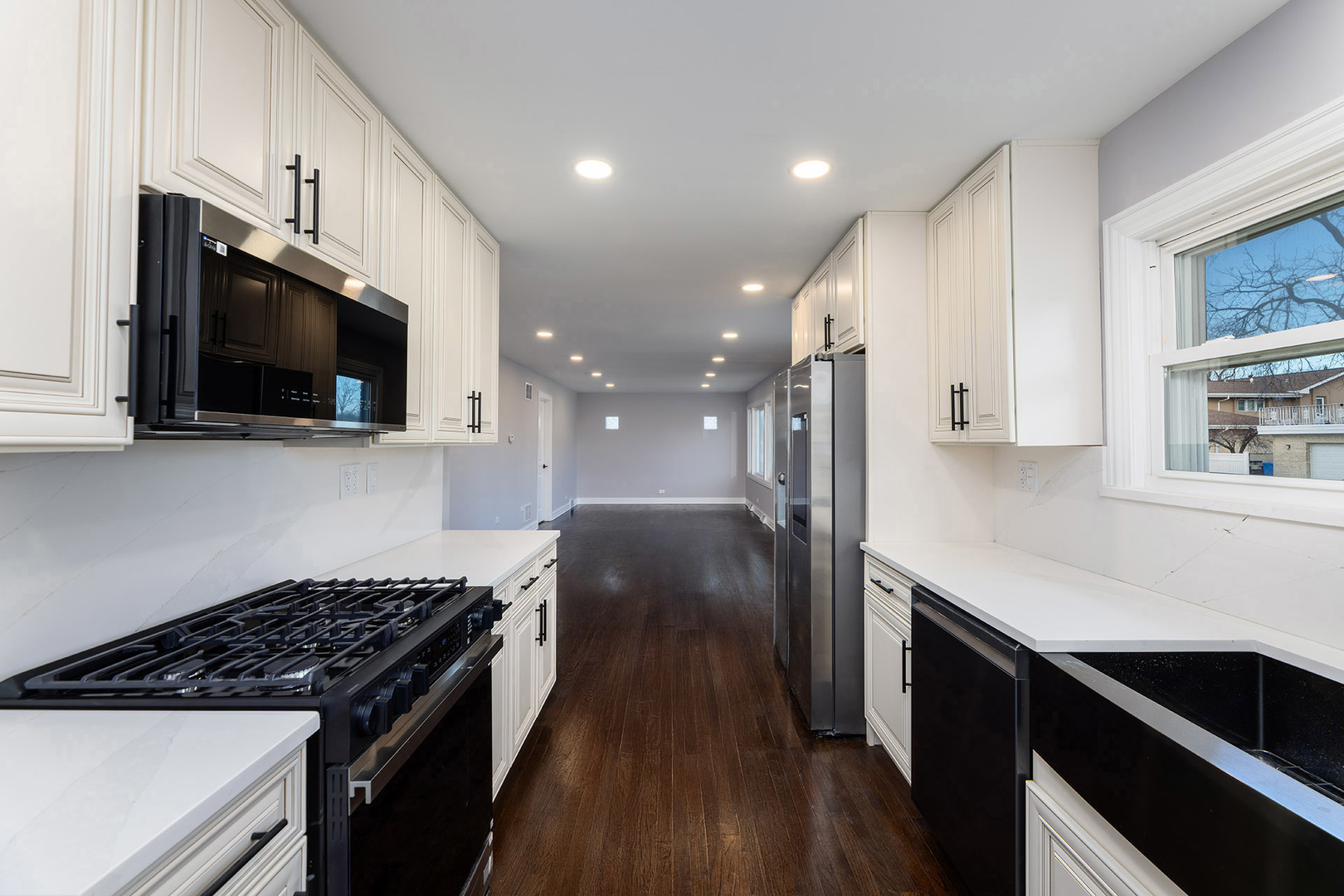4955 North Delphia Avenue Norridge, IL 60706 - Photo 13 of 36 a kitchen with a sink a microwave and cabinets