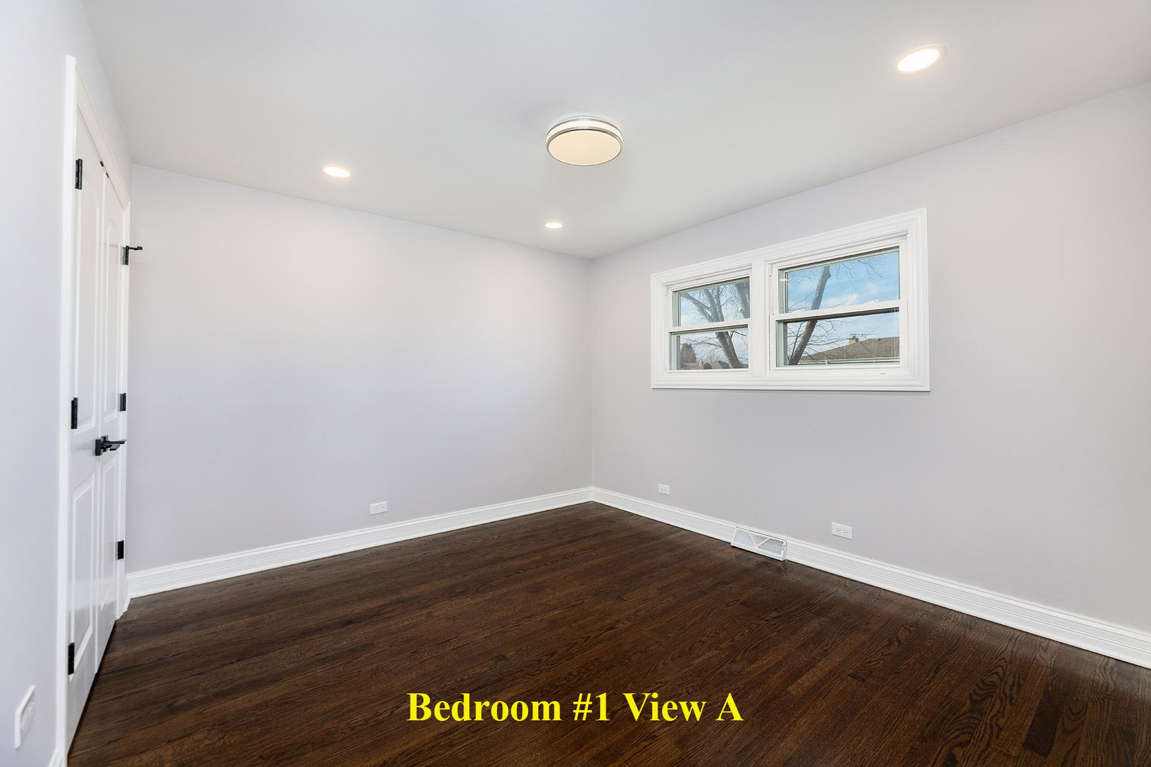 4955 North Delphia Avenue Norridge, IL 60706 - Photo 14 of 36 an empty room with wooden floor and windows