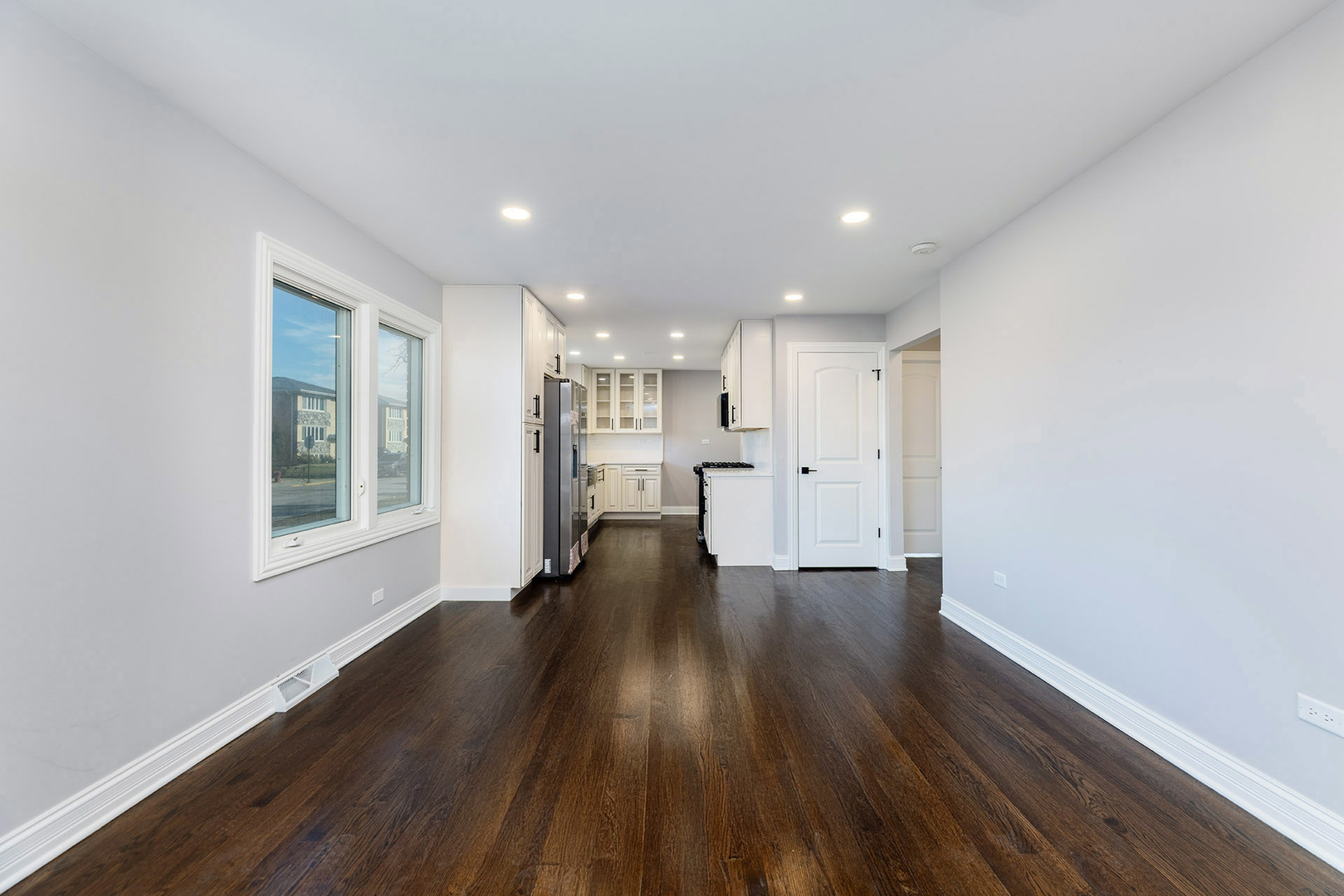 4955 North Delphia Avenue Norridge, IL 60706 - Photo 7 of 36 a view of an empty room with wooden floor and a window