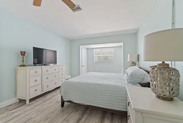 a bedroom with a bed and flat screen tv