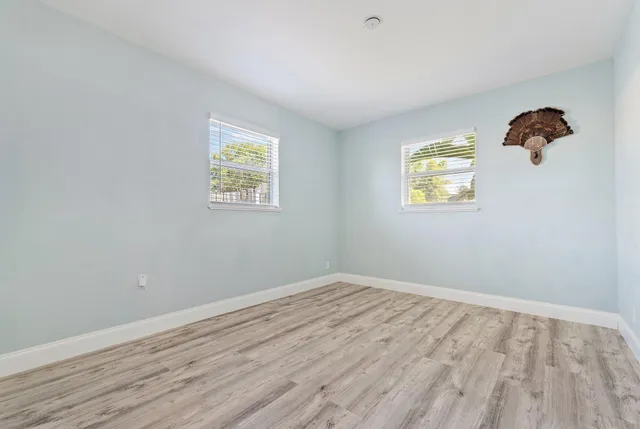 wooden floor in an empty room with a window