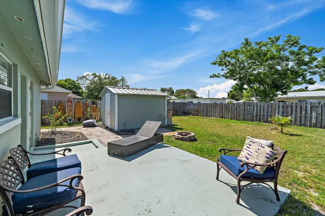 a view of a patio with furniture and a yard