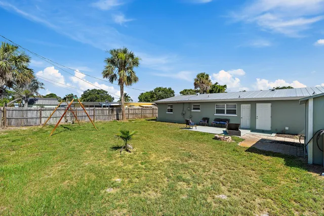 a view of a backyard with furniture