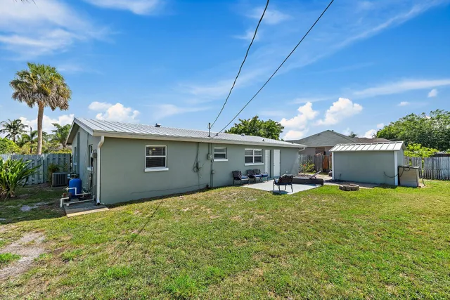 a view of a house with a yard and sitting area