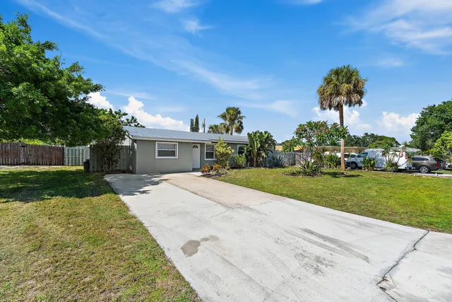 a front view of a house with a yard and a garage