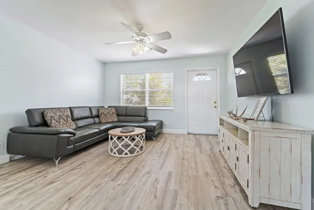 a spacious bedroom with a bed and a chandelier