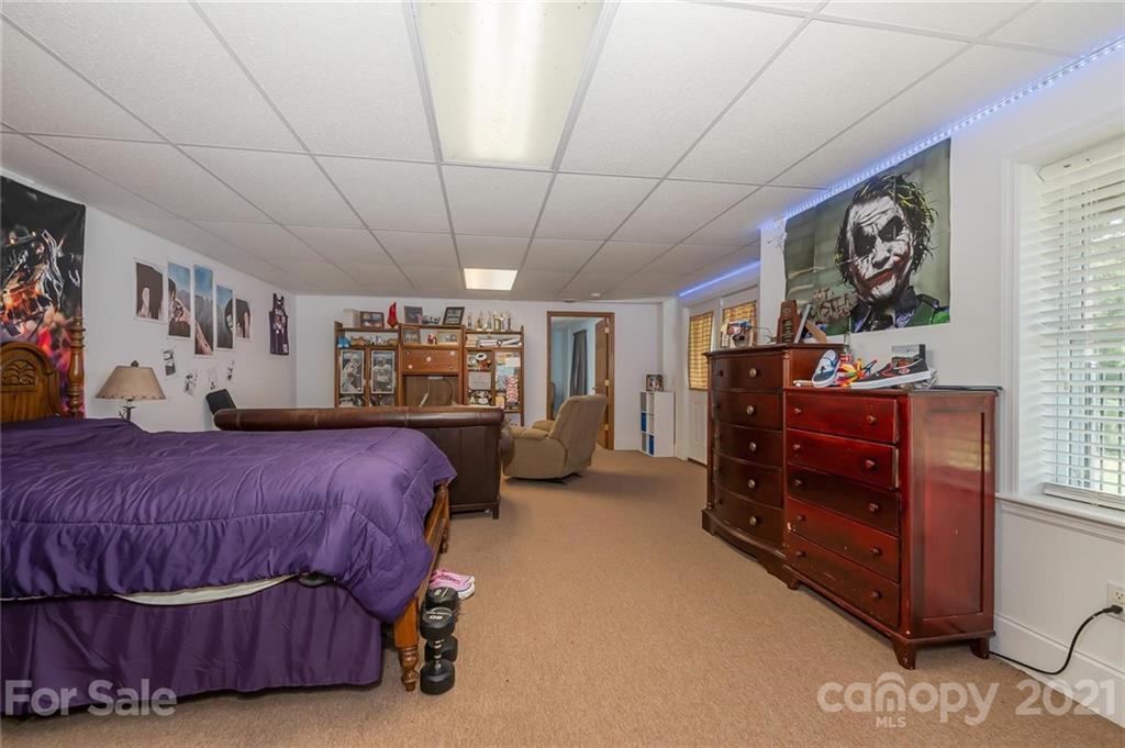 868 Henry Ruff Road Mill Spring, NC 28756 - Photo 22 of 48 a bedroom with a bed and a walk in closet