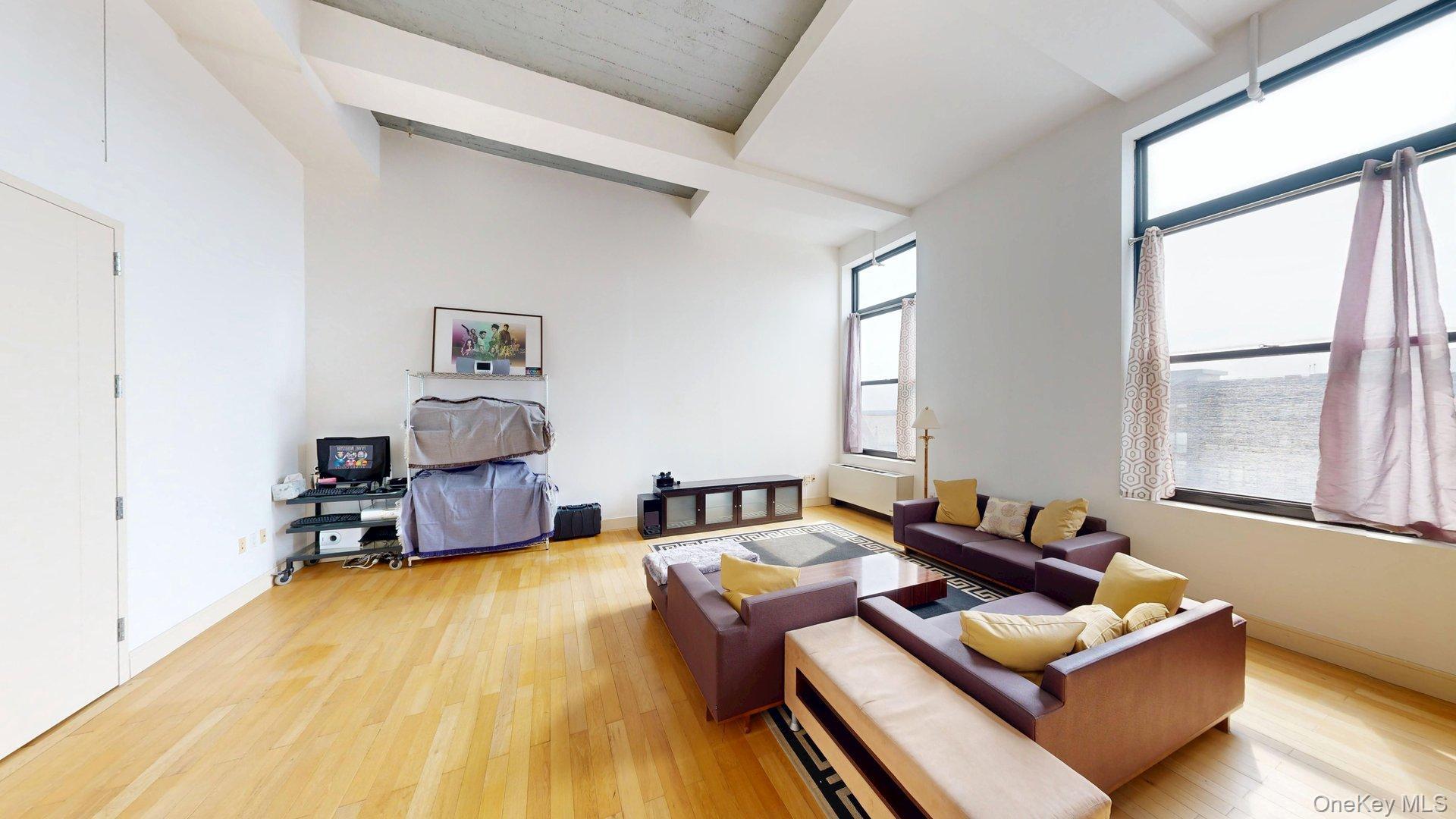 25 Leroy Place, Unit 509 New Rochelle, NY 10805 - Photo 2 of 12 a living room with furniture and a table