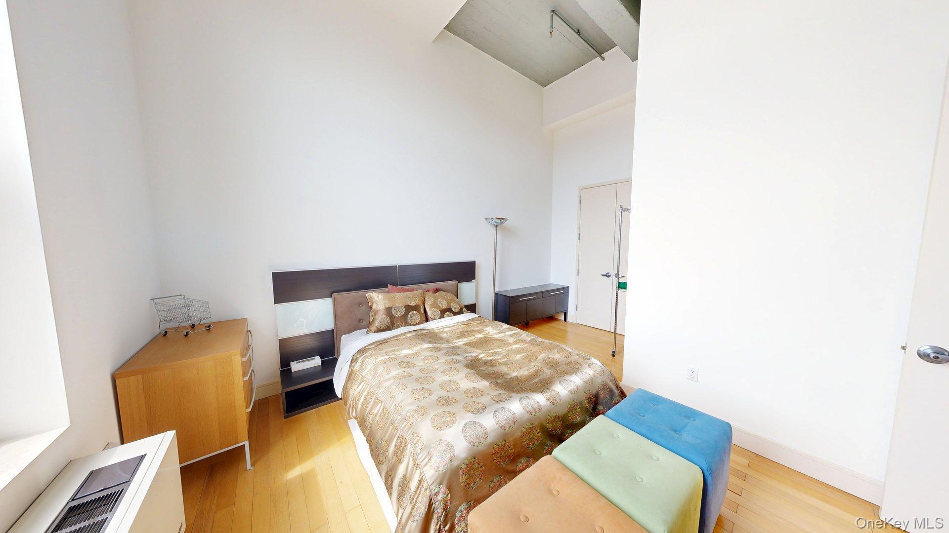 25 Leroy Place, Unit 509 New Rochelle, NY 10805 - Photo 6 of 12 a bedroom with a bed and chair