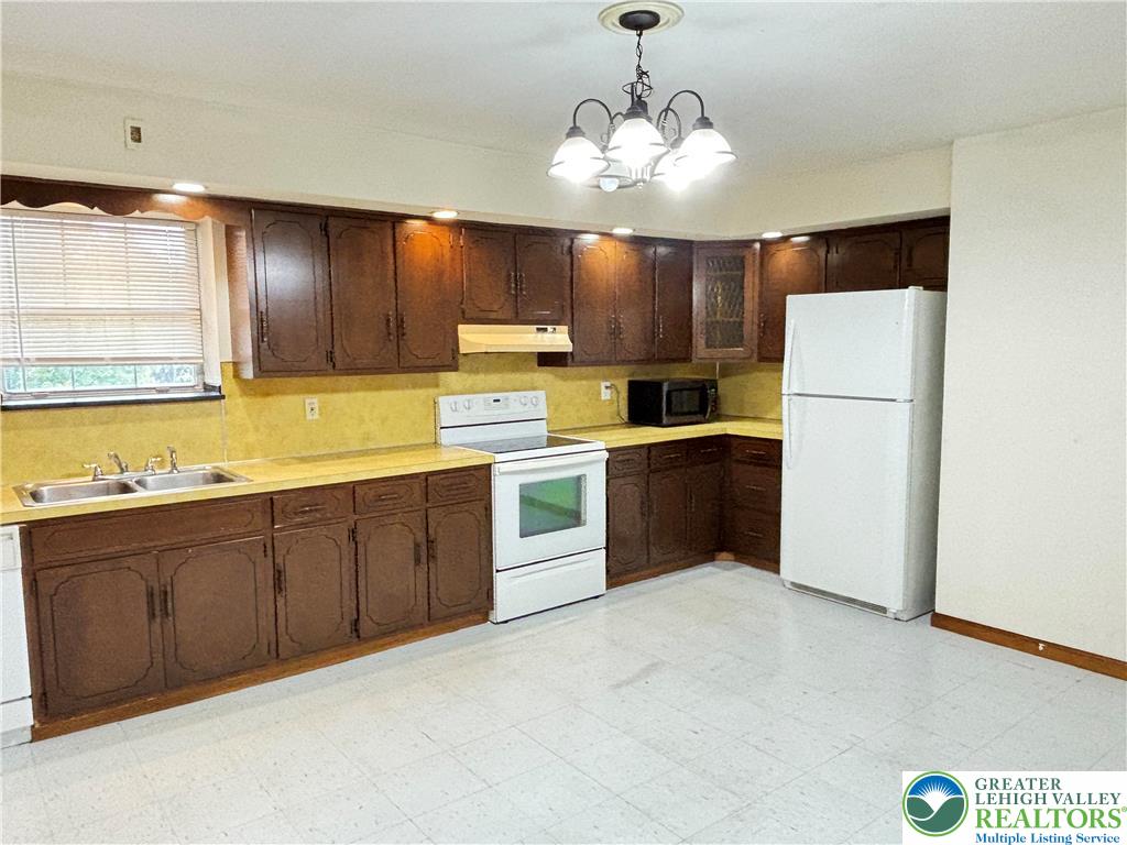2027 Willow Park Road, Unit 7 Bethlehem, PA 18020 - Photo 22 of 27 a kitchen with cabinets a sink and white appliances