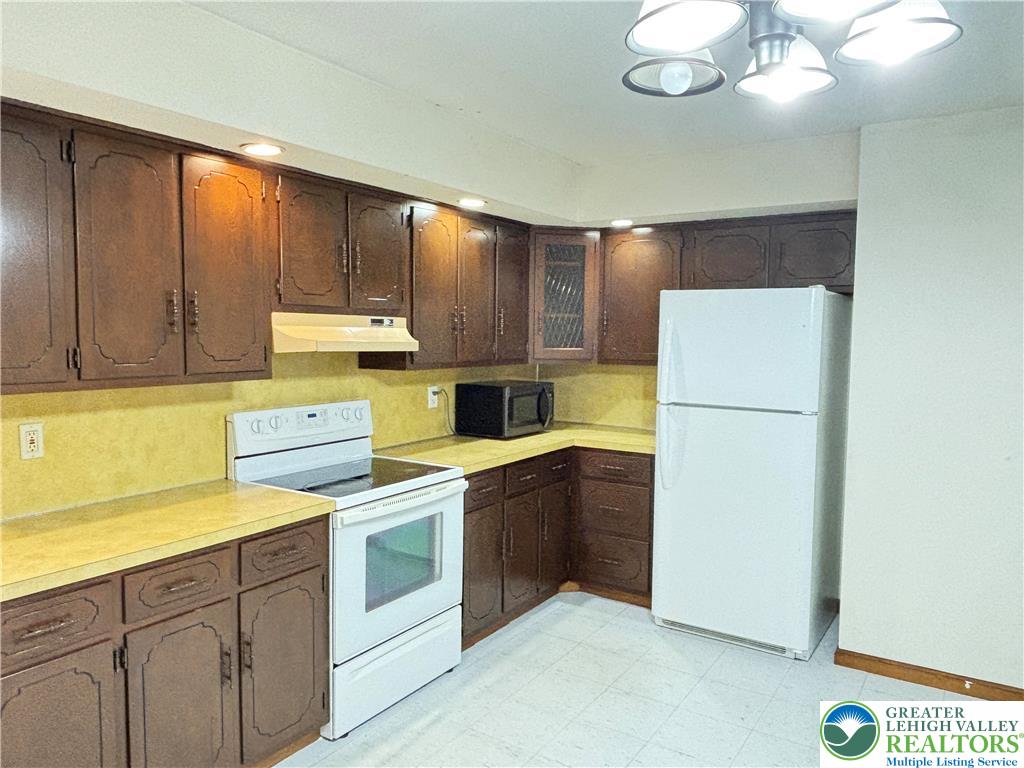 2027 Willow Park Road, Unit 7 Bethlehem, PA 18020 - Photo 3 of 27 a kitchen with a refrigerator sink and cabinets