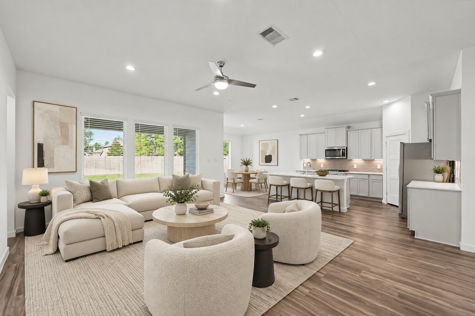 14162 Primrose Ridge Lane Conroe, TX 77384 - Photo 14 of 48 Experience seamless living in this beautifully staged open-concept space, featuring a cozy living area, modern kitchen, and abundant natural light.