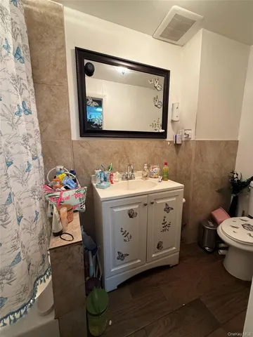 a bathroom with a toilet sink and mirror