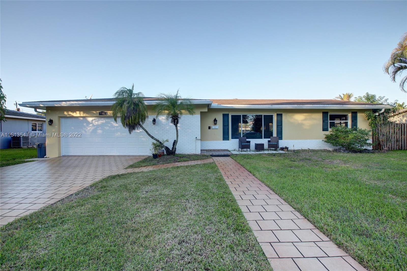 6681 Peters Road Plantation, FL 33317 - Photo 1 of 27 a front view of house with yard and green space