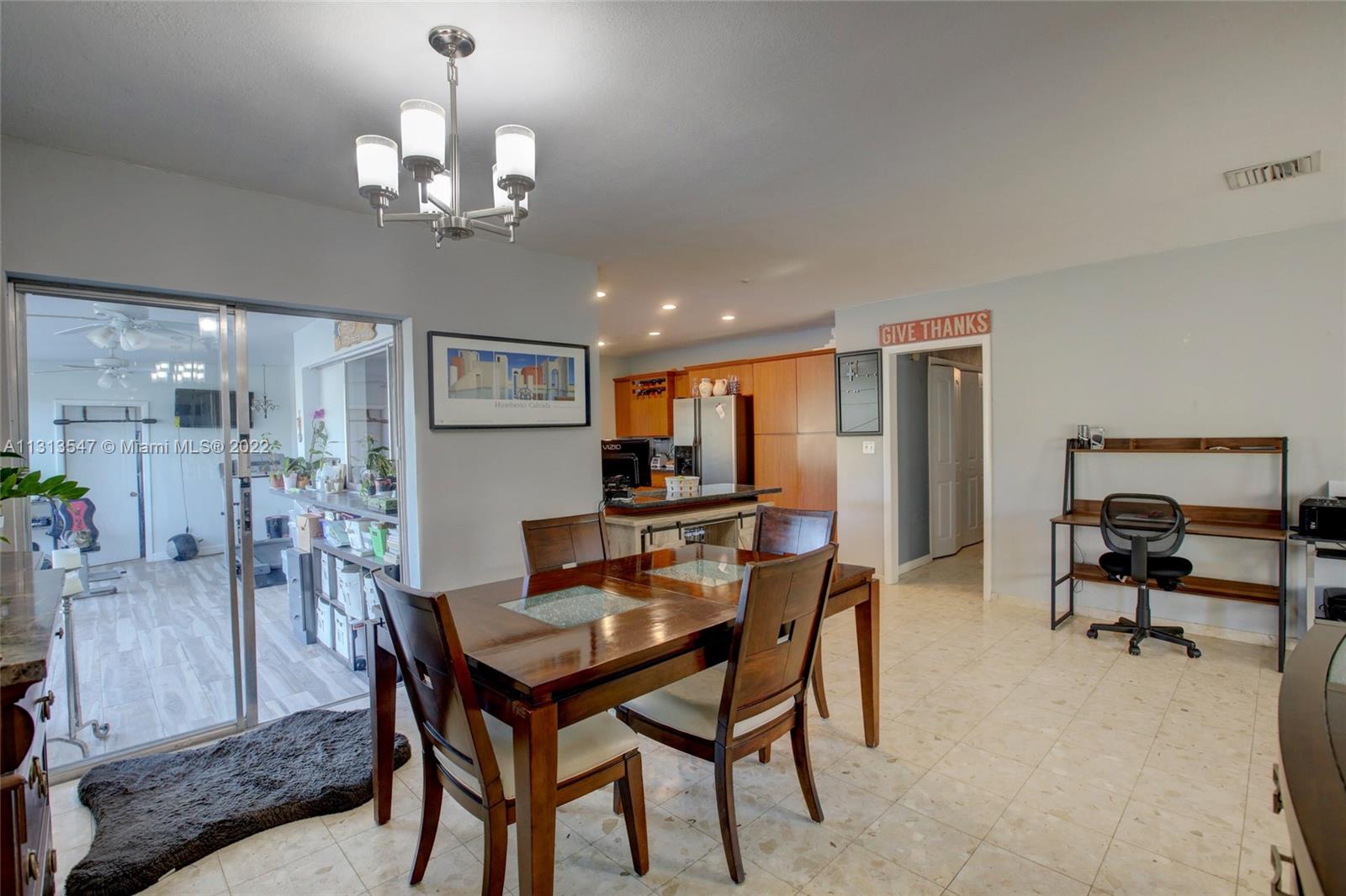 6681 Peters Road Plantation, FL 33317 - Photo 13 of 27 a view of a dining room with furniture and a chandelier
